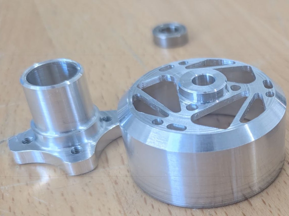 First-article LodeIron 2812 bell and base machined from 7075-T6 aluminum, shown with a bearing